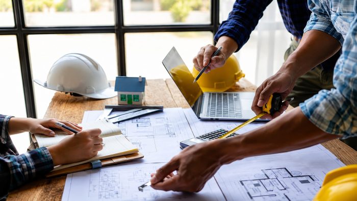 Construction Team Reviewing Blueprints and Project Plans